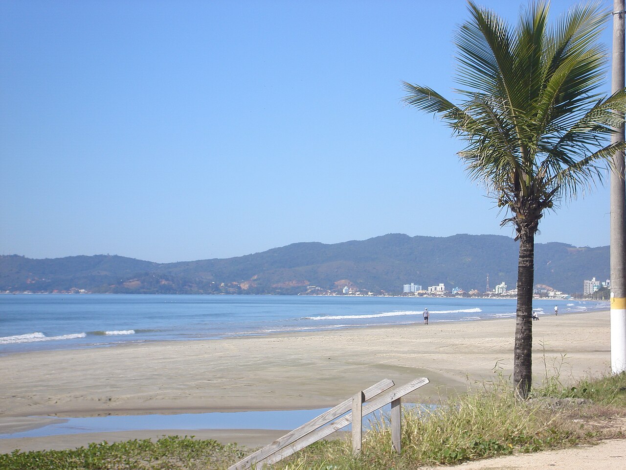 Fotografia real da praia e dos edifícios de Meia Praia em Itapema, Santa Catarina
